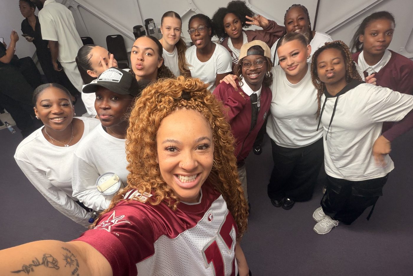 Warriorz dancers backstage together in matching white t-shirts
