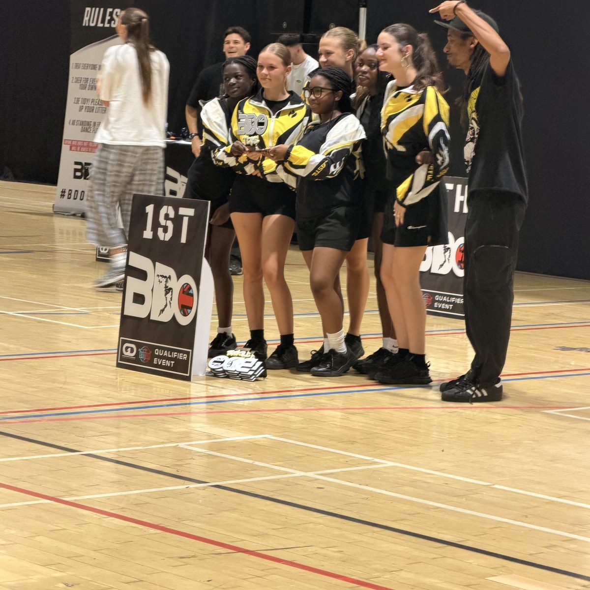 A Warriorz crew beside a first place board at a BDO qualifier event