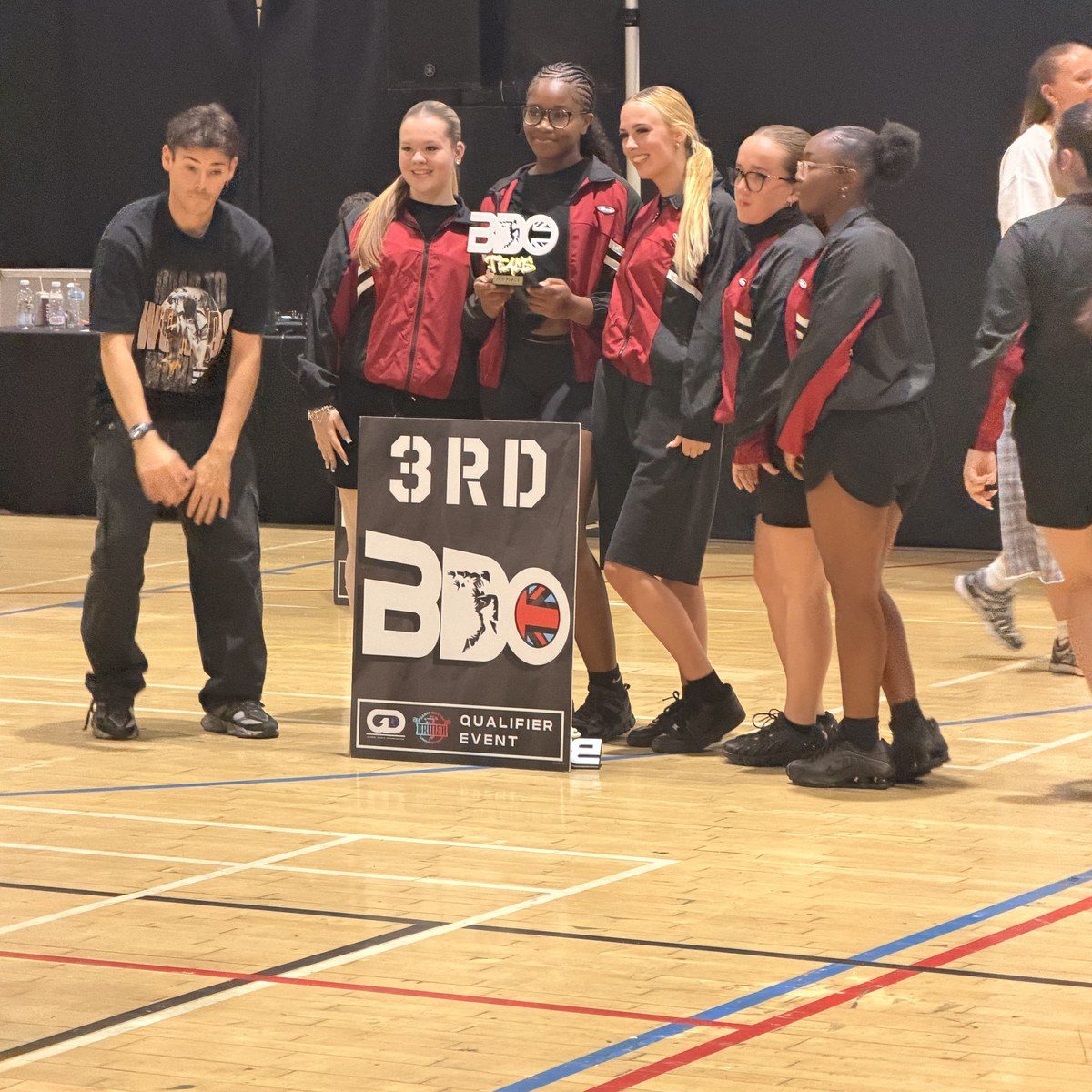 A Warriorz crew beside a third place board at a BDO qualifier event