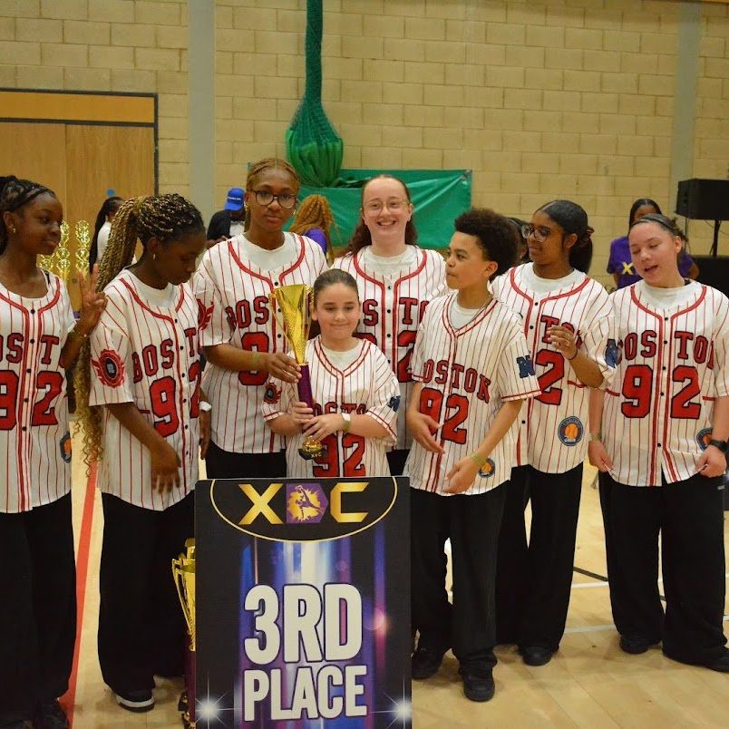 A Warriorz crew in baseball jerseys beside an XDC third place board