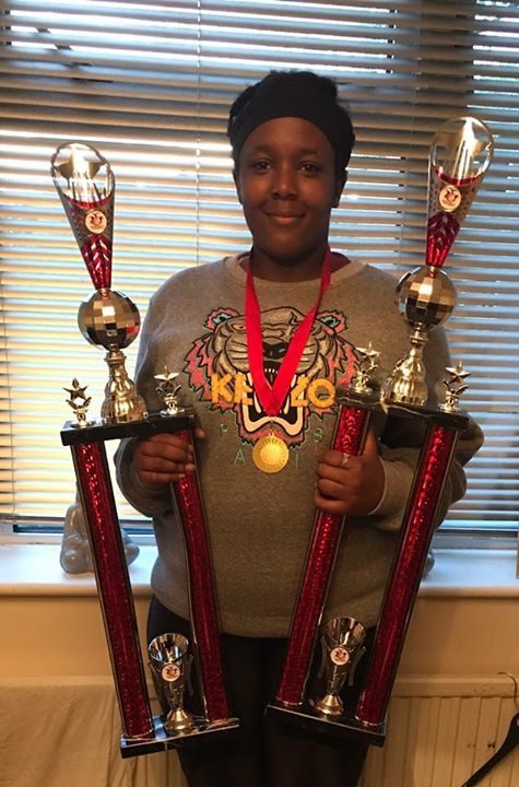 A Warriorz dancer with competition trophies